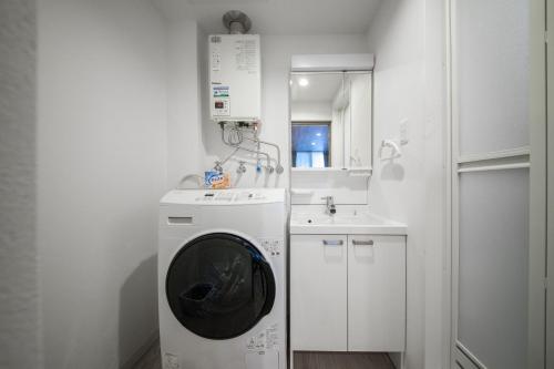 a white kitchen with a washing machine and a sink at ASPEN【2min from Asahikawa sta】 in Asahikawa