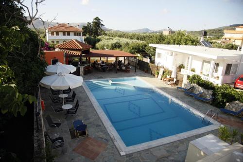 an overhead view of a swimming pool with an umbrella at Kalliopi Hotel in Kastéllion