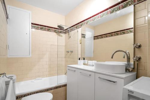 a white bathroom with a sink and a toilet at Cliveden - A Heritage Hideaway with Rooftop Pool in Sydney
