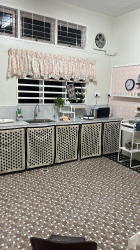 a kitchen with a sink and a counter top at The Hidden 7 in Taiping