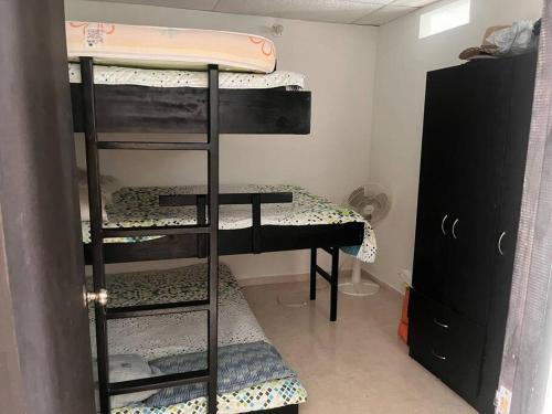 a room with three bunk beds in a room at Descansa con tranquilidad in Villavicencio