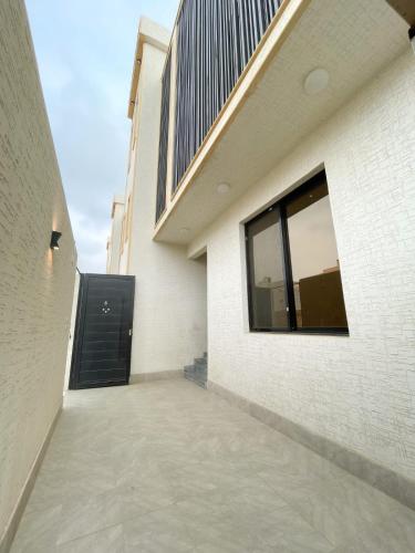 a walkway leading to a building with a black door at نزل الراشد الفاخرة luxury in Abha