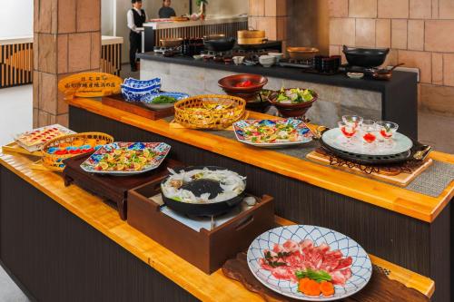 a buffet with many plates of food on a table at Takamiya Hotel Lucent in Zao Onsen
