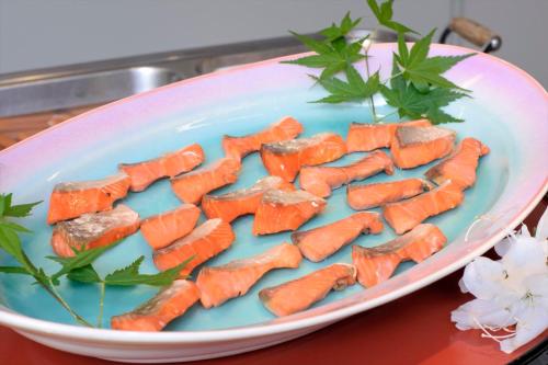 a plate filled with carrots on a table at Takamiya Hotel Lucent in Zao Onsen