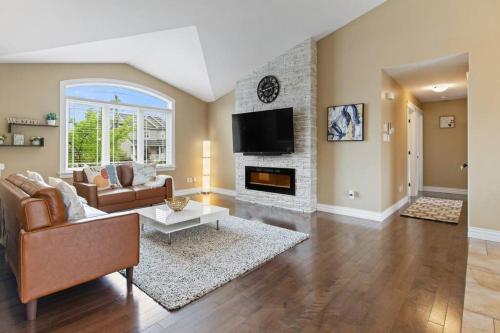 a living room with a couch and a fireplace at Le Cozy Clover in Moncton
