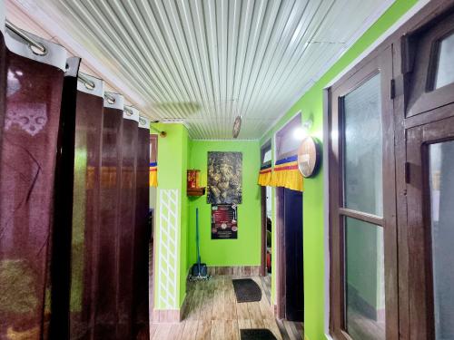 a hallway with green walls and a ceiling at Neoravalley Homestay, Icche Gaon in Pedong