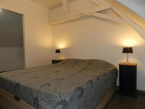 a bedroom with a bed and two lamps on tables at Charmante Fermette avec Jardin, Terrasse et 4 Chambres - Idéale pour Familles et Amis - FR-1-410-436 in Avessé