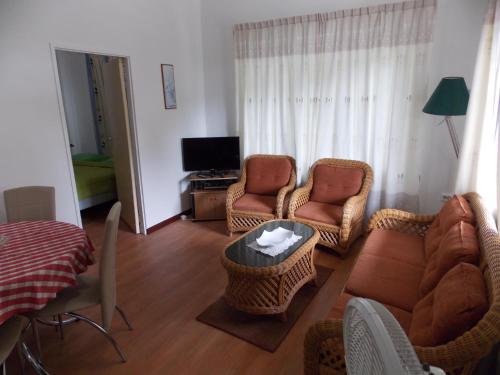 a living room with two chairs and a couch at At Rachel in Paramaribo