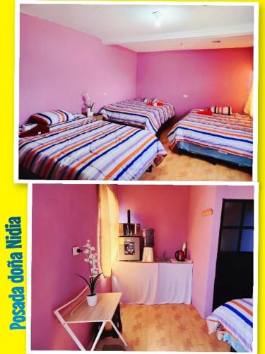 Duas camas num quarto com paredes cor-de-rosa e roxo em Posada doña Nidia em Quetzaltenango