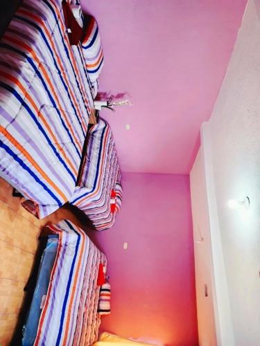 Tempat tidur dalam kamar di Posada doña Nidia
