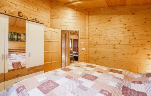 a bedroom with a bed in a wooden room at Awesome Home In Merzalben With Wi-fi in Merzalben