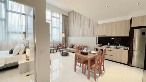 a kitchen and living room with a table and a couch at Moulmein Studios by K&C Serviced Apartment in Singapore
