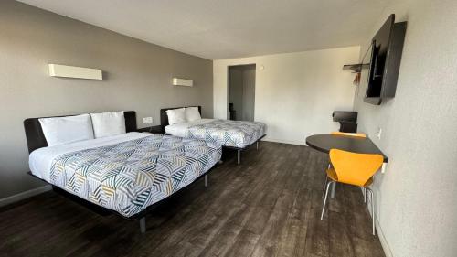 a hotel room with two beds and a desk at Motel 6-Delano, CA in Delano