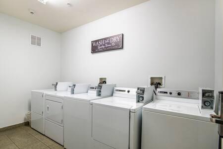 a row of white washing machines in a room at Vistas 201- Modern Sierra Vista 1bd great location in Sierra Vista