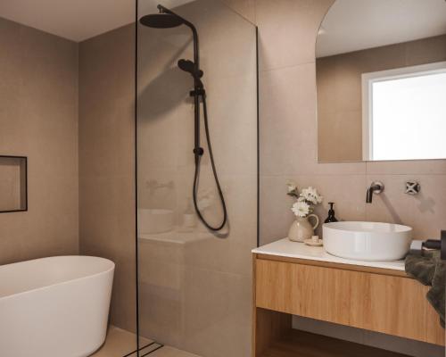 ein Badezimmer mit einer Dusche, einer Badewanne und einem Waschbecken in der Unterkunft Architect Home with View in Central Hobart in Hobart