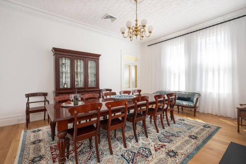 a dining room with a table and chairs at Luxury at Lauralla - An Elegant Victorian Escape in Mudgee