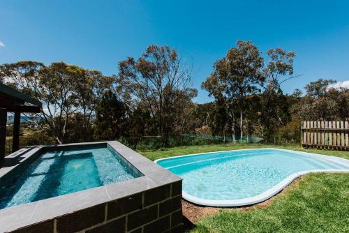 a swimming pool in the yard of a house at 'Tyalla Lodge' Unique Luxe Design in the Mountains in Mudgee