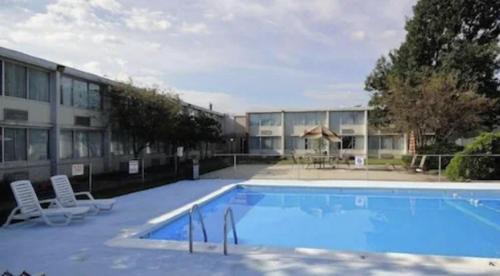 a large swimming pool in front of a building at Fairborn Hotel and Inn in Fairborn