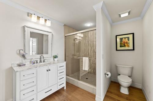 a white bathroom with a shower and a toilet at Catina Golf Condo at the Lely Resort in Naples