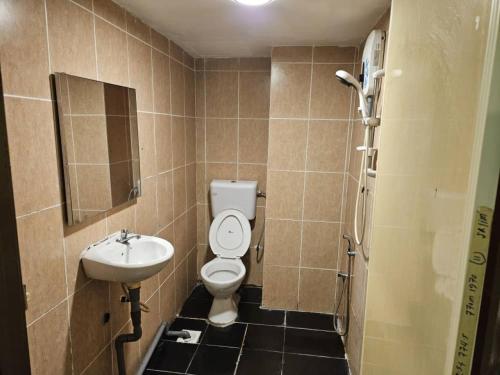 a bathroom with a toilet and a sink at HOTEL Rampai Rooms in Kuala Lumpur