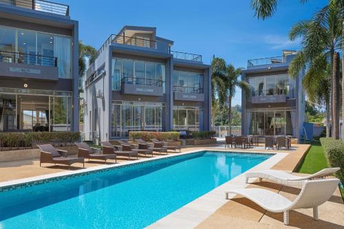 an exterior view of a building with a swimming pool at Pool Access Villa Argent 8, 3-Bedroom near Mission Hills Golf in Thalang