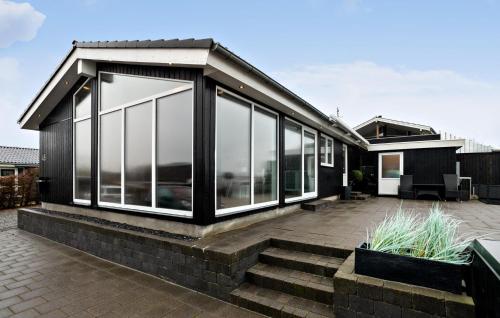 a house with glass windows and a patio at Awesome Home In Haderslev in Haderslev