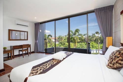 a bedroom with a large white bed and a desk at 3BR Villa next MissionHills Golf Villa Argent 7 in Ban Muang Mai