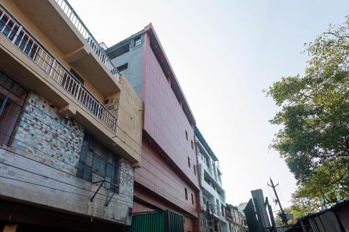 a building with a balcony on the side of a street at FabHotel Prime Oasis Orange in Bhopal