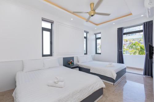 a bedroom with two beds and a ceiling fan at B2.20 Hoàng Sơn in Vung Tau