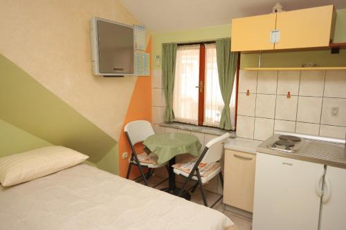 a small room with a bed and a table and chairs at Apartments by the sea Split - 7602 in Split