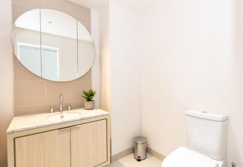 een badkamer met een wastafel en een spiegel bij City Road Sanctuary with Sunset Views & Parking in Melbourne