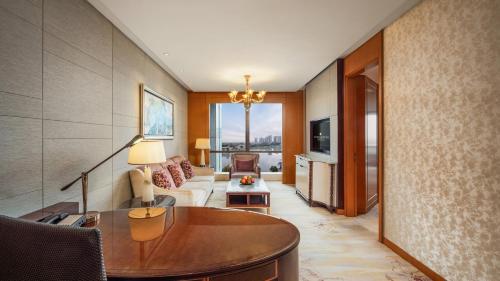 a living room with a table and a couch at InterContinental Changzhou by IHG in Changzhou