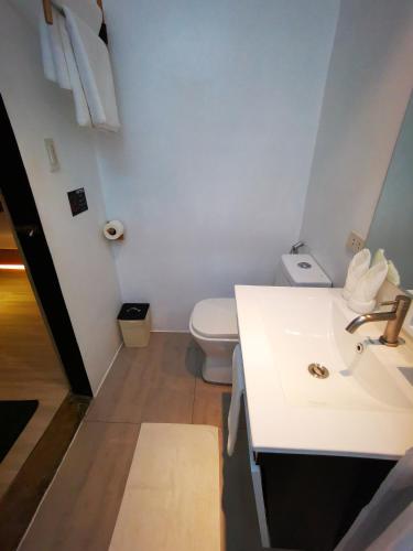 a bathroom with a white sink and a toilet at Urban Boutique Hotel in Boracay