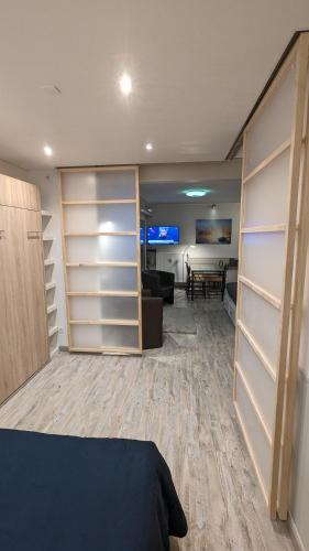 a room with shelves and a bed and a living room at Datcha Bourguignonne Beaune in Beaune