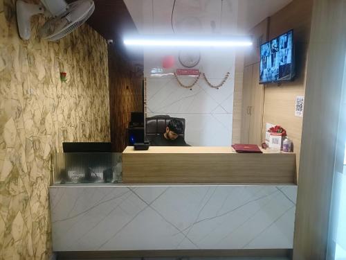 a dog sitting at the counter of a coffee shop at ROYAL PRIME HOTEL in Vadodara