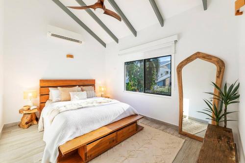 a bedroom with a large bed and a mirror at 'Villa Nalu' A Dreamy Fannie Bay Escape in Fannie Bay