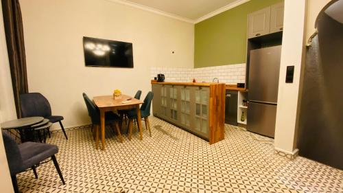 a kitchen with a table and chairs and a refrigerator at The House Company in Istanbul