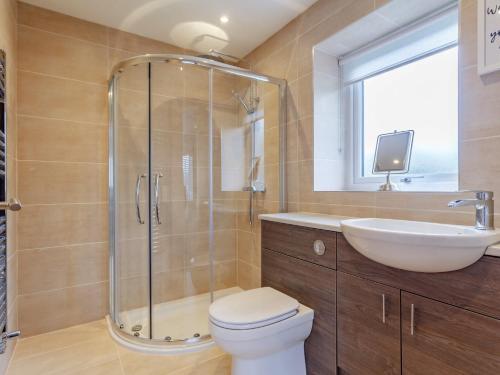 a bathroom with a shower and a toilet and a sink at 6 Bed in Marazion 77228 in Saint Hilary