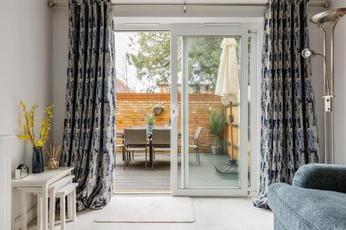 a living room with a sliding glass door at Modern, comfy Town centre gem, near beach, parking in Bournemouth