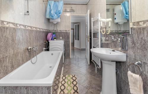 a bathroom with a tub and a sink at Apartments Sweet Home in Otočac