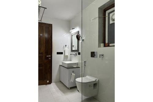 a bathroom with a toilet and a sink at The Grand Shekhawati in Rāmsir