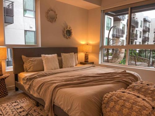 a bedroom with a large bed with a large window at Luxury 1BDR centrally located in Hollywood in Los Angeles