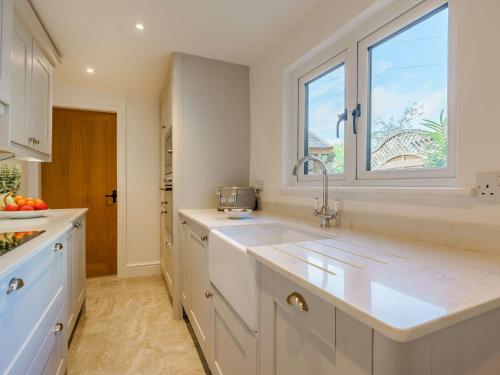 a white kitchen with a sink and a window at 3 Bed in Great Ayton 85937 in Great Ayton