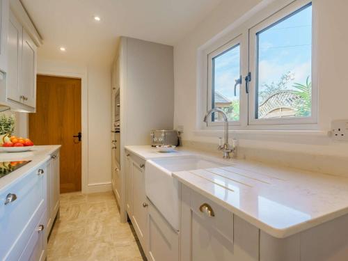 a white kitchen with a sink and a window at 3 Bed House With Hot Tub Great Ayton - TOP Terrace in Great Ayton