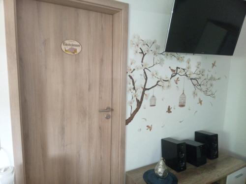 a room with a door with a tree on the wall at Wohnung Auszeit in Wald