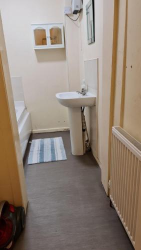 a bathroom with a white sink in a room at Regent Apartments - Glasgow City in Glasgow