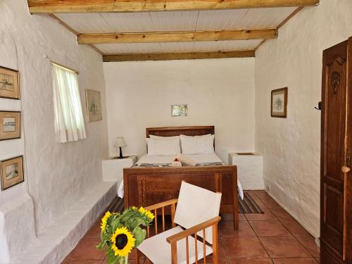 a bedroom with a bed and a table and chairs at Whipstock Guest Farm in McGregor