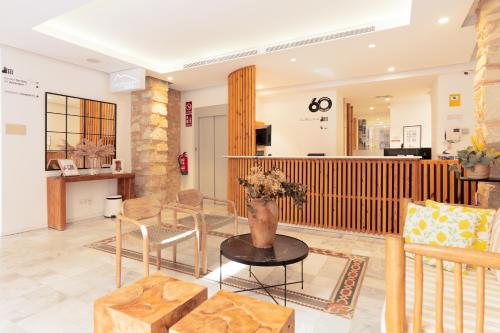 a lobby with a vase of flowers on a table at Hotel La Milagrosa in Alicante