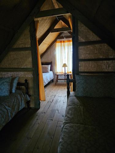 a attic room with two beds and a window at Whipstock Guest Farm in McGregor