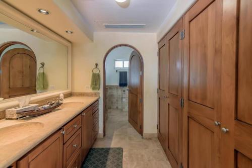 a bathroom with wooden cabinets and a sink at Entire Beachfront condo in Paradise in San José del Cabo